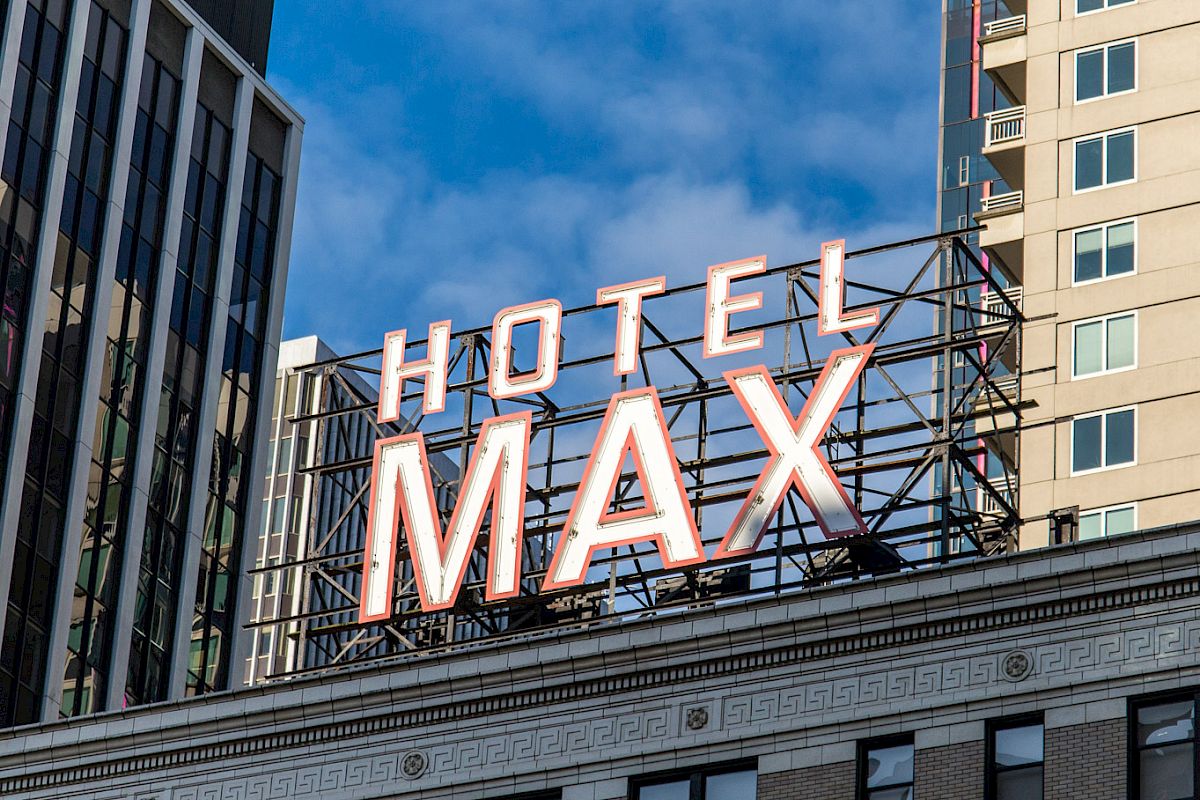 The image shows a building with a large illuminated sign that reads 