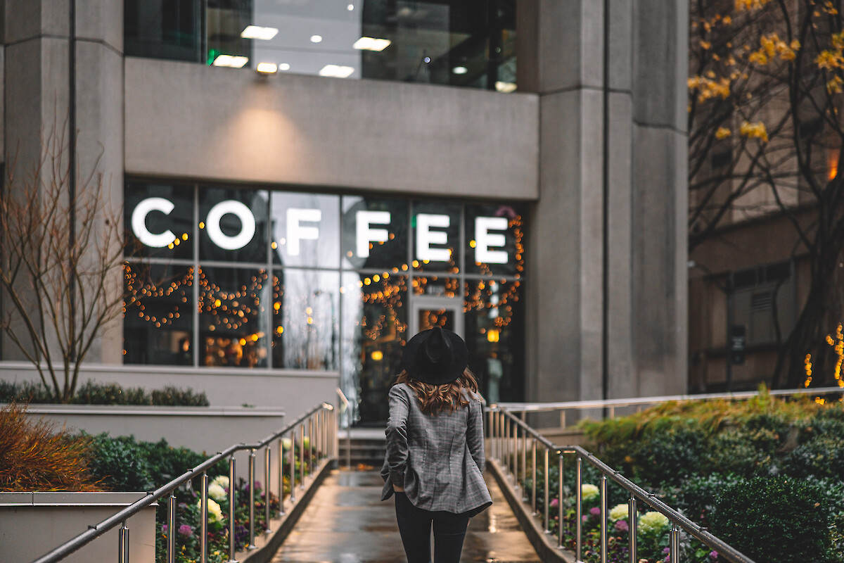 A person walks toward a building with a large 