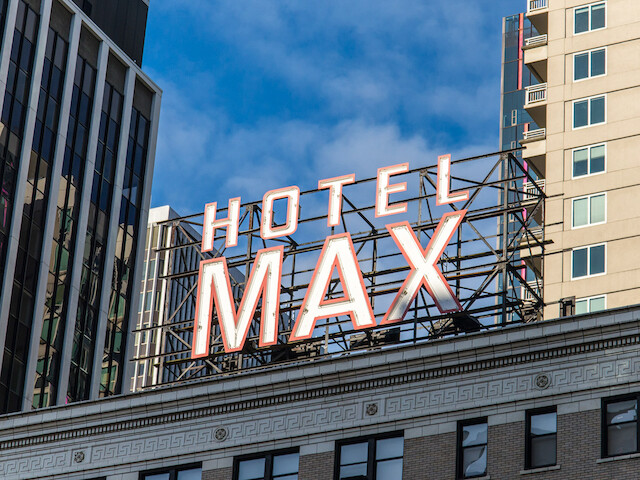 A large sign atop a building reads 