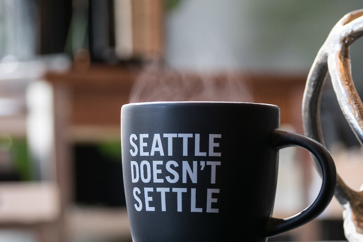 A black coffee mug with the phrase 