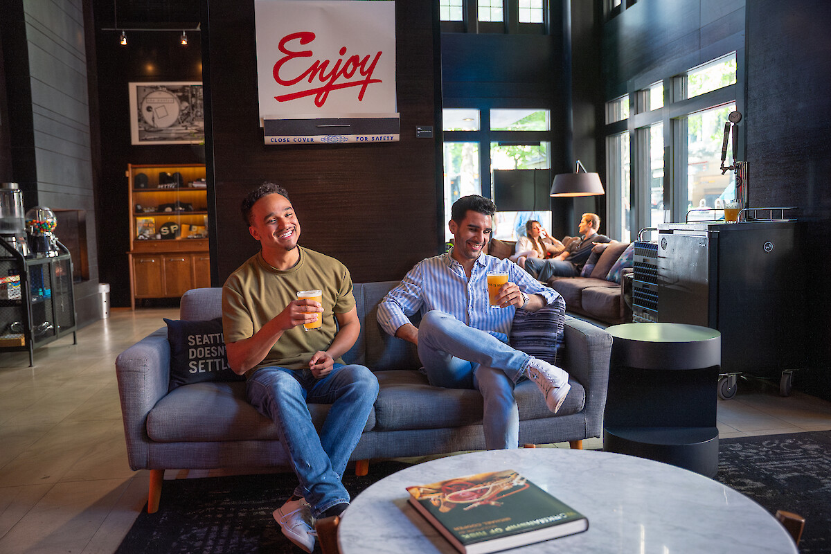 People enjoy drinks and conversation in a cozy, modern lounge with a 